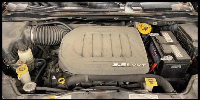 Dust-covered 3.6-liter engine bay before specialty cleaning