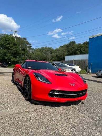 Red Chevrolet Corvette with a clean glossy exterior after detailing